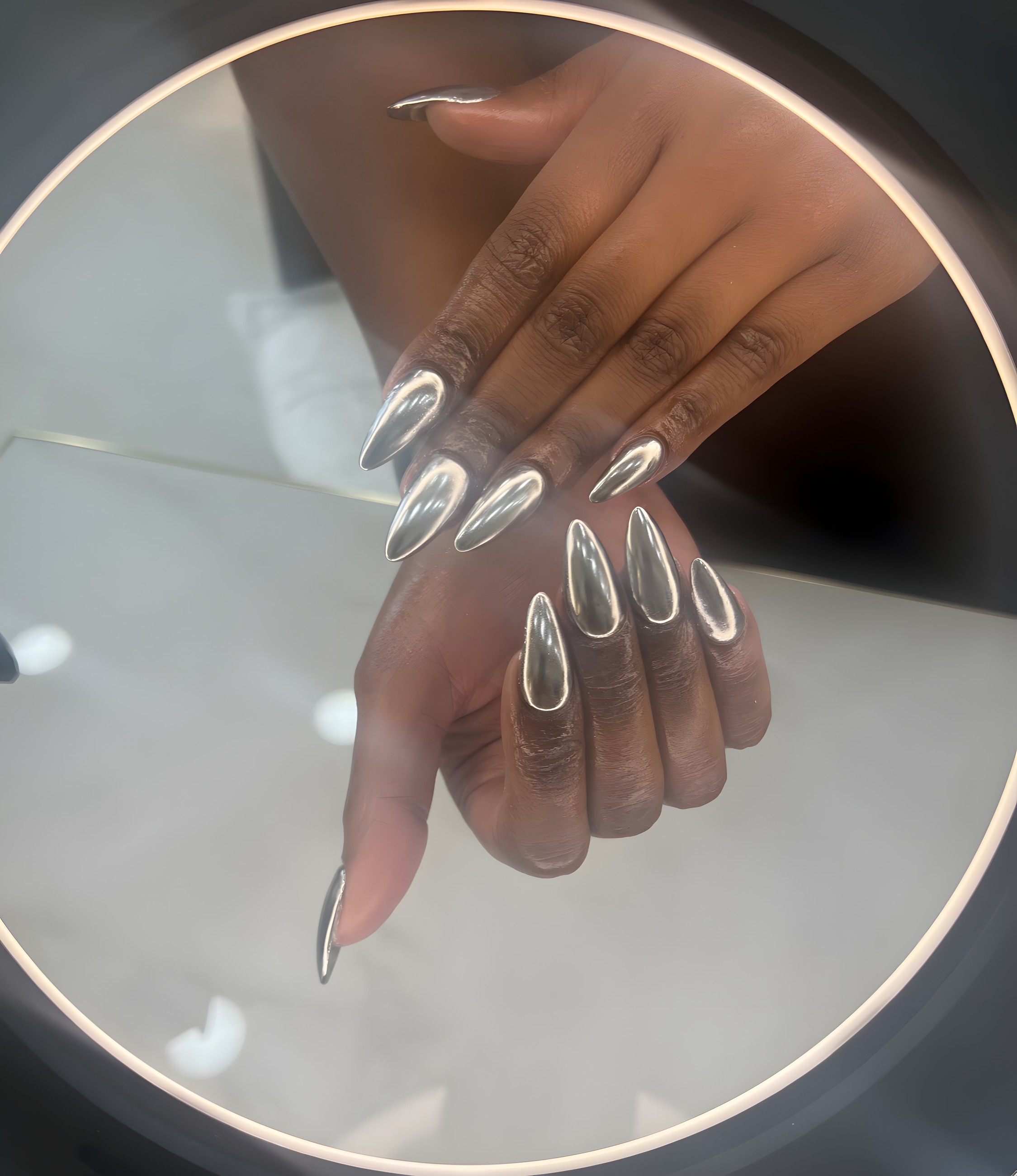 Mirror-chrome silver stiletto nails, done at Lashes&Nails by Vali