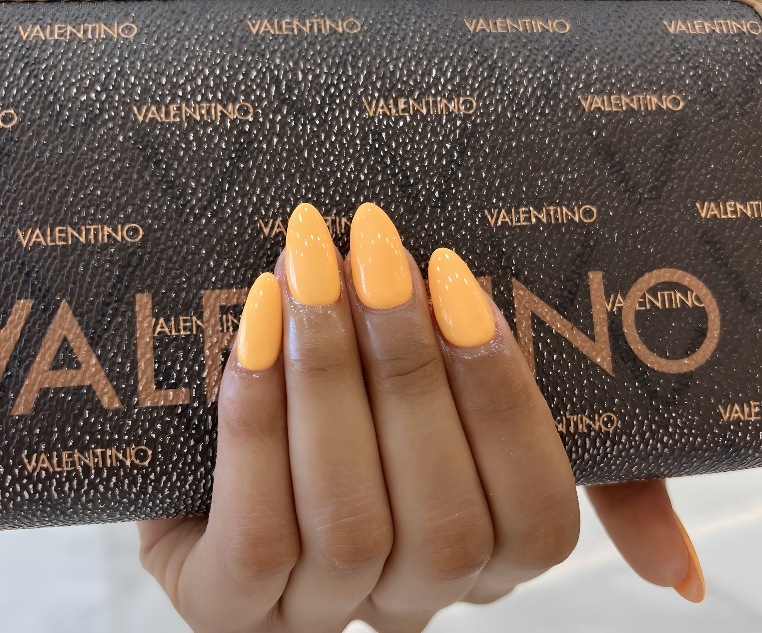 Bright almond nails in a warm orange gel